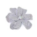 Close-up detail of sparkling rhinestone flower patch brooch with colorful center crystal. - AB Color