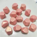 Close-up of pink irregular diamond acrylic loose beads, glossy mermaid finish, DIY craft. - Pink