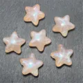 Close-up detail of shiny mermaid star beads, perfect for DIY phone charms and crafts. - Orange