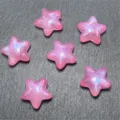 Close-up detail shot of shiny pink star-shaped resin beads for handmade DIY jewelry crafts. - Rose Red
