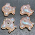 Detailed view of cute airplane shaped acrylic beads with mermaid glitter finish for DIY jewelry crafting. - 25x28mm / Light Orange / Champagne