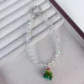 Crystal beaded phone charm detail showing sparkling wheel cut beads and cute Christmas tree pendant. - White Wheel & Christmas Tree