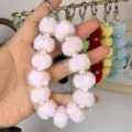 Plush pom pom phone charm and bag keychain with faux pearls, fluffy winter accessory for women. - Pink