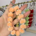 Fluffy pom pom pearl wristlet strap keychain for phone bag charm accessory details view - Orange