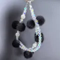 Crystal beaded phone charm with black fluffy pom-poms, double strand wrist strap lanyard. - Black