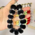 Black plush pom pom phone charm with faux pearls and metal clips variant item display - Black