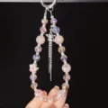 Korean ins pink iridescent beaded phone charm with star tassel pendant and elegant design. - Pink