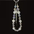 Detailed view of the Korean style crystal beaded phone charm with sparkling rhinestone tassel. - White