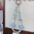 Close-up detail of light blue crystal beaded phone and bag charm with rose flower balls. - Glacier Blue Rose Flower