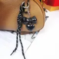 Chic black bow and heart bag charm with braided rope keychain for stylish accessories. - Black