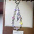 Close-up of handmade crystal beaded phone charm with pink and purple beads and star pendant. - Star Charm / Purple