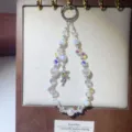 Detailed view of handmade crystal beaded phone charm with shooting star pendant, shiny. - Star Charm / White