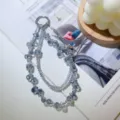 Detailed shot of sparkling blue crystal beaded wrist strap with cute bow and metal ring. - Light Blue Grey