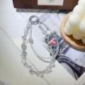 Detailed view of handmade crystal beaded phone charm with sparkling butterfly and silver ring. - Clear White