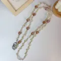 Detailed view of sparkly crystal flower bead phone lanyard with amber charms and metal rings. - Crossbody-Coffee