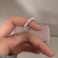 Close-up view of sparkling zircon ball and pearl elastic ring, Korean chic detail design. - Pearl Zircon Elastic Ring / White