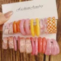 Detailed view of vibrant colorful resin C-shaped hoop earrings displayed on white card. - Pink Orange Plaid Style (Set 16)