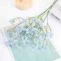 Detail shot of artificial baby's breath flowers bouquet, blue floral arrangement close-up decor. - Blue