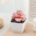 Closeup of artificial flocked pink succulent in a white square pot with stones for indoor decor. - Flocked Style 9