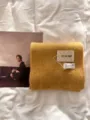 Detailed view of a soft yellow knitted scarf, featuring cozy thick texture and chic style. - Ginger Yellow