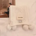 Solid color pompom knitted scarf for women, cozy winter warm fashion accessory detail view. - White