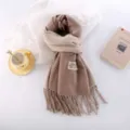 Detailed shot of a thick two-tone cashmere-feel winter scarf with elegant fringe design. - Shrimp Rice Color
