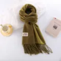 Thick imitation cashmere scarf in solid olive green with fringe detail and woven label accent. - Mustard Green