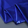 Close-up detail shot of royal blue metallic shiny fabric, showing smooth texture and glossy finish. - Sapphire Blue