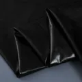 Glossy black faux leather fabric detail view, smooth surface with bright luster and drape. - 100cm Shoulder to Hem / Black
