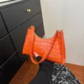 Orange crocodile pattern baguette bag, trendy underarm shoulder handbag for women. - Orange