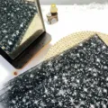 Black starry mesh fabric for sleeves and apparel, sheer glitter starry tulle material. - Black