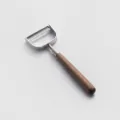 Stainless steel vertical peeler with a solid walnut wood handle for kitchen cooking use. - Horizontal Peeler