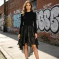 Detailed shot of a black long-sleeve top and sequin high-low skirt in urban street style. - One Size / Bottoms / Black