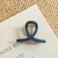 Detailed close-up of dark blue hair claw clip with golden metal spring for elegant hairstyles. - Small Cross / 8cm / Indigo