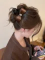 Detail shot of a brown satin bow hair claw clip with a sparkling rhinestone in the center. - High Quality Small 8cm Round Spring / Coffee
