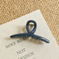 Close-up detail of dark blue geometric hair claw clip, showing durable metal spring and finish. - Large Cross / 13cm / Indigo