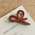 Detailed view of large brown resin hair claw clip with unique abstract loop design and spring. - Medium Shape / 11cm / Chocolate Brown