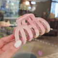 Detail shot of pink marbled hair claw clip, elegant large shark clip for thick hair styling. - Pink Garden