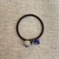 Detailed shot of a simple acetate bow hair tie with high elasticity for women daily styling. - Purple Bow