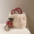 Plush bucket handbag detail showcasing fluffy white faux fur texture and pink braided handles. - Cherry Pink