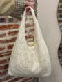 Close-up detail of cream white floral embroidered canvas tote shoulder bag daily casual. - White