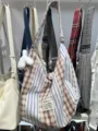 Canvas patchwork shoulder bag detail showing striped plaid pattern and cute plush bunny pendant. - Without Charm / Plaid