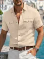 Close-up detail of mens short sleeve linen shirt with dual utility chest pockets in beach scene. - S / Tops / Apricot