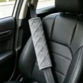 Plush car seat belt shoulder pad detail shot, soft grey fleece cover for comfort. - M Pattern Shoulder Pad / M Pattern Gray Pair