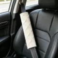 Plush car seat belt cover in beige soft material with elegant embossed geometric design. - M Pattern Shoulder Pad / M Pattern White Pair