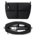 Black quilted puffer cosmetic bag and travel tech organizer with large capacity zipper. - Black