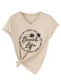 Close up detail of women casual V-neck t-shirt featuring beach life print and knot hem. - S / Sand