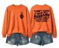 Detailed view of the orange long-sleeve graphic sweatshirt showcasing back quote design. - Orange (Black Letter Graphic)