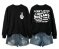 Detailed view of the casual black sweatshirt featuring humorous back text and skeleton hand print. - Black (White Letter Graphic)