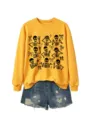 Women's cute Halloween skeleton graphic crewneck sweatshirt paired with stylish denim shorts. - S / Tops / Yellow